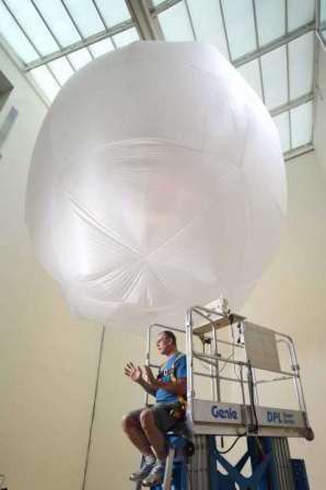 Bob Self/Staff Photographer Ian Johnston sits atop a lift in the atrium at MOCA Jacksonville after putting the finishing touches on his sculpture, "Fish Tales," which is the latest work to be installed as part of the Museum of Contemporary Art Jacksonville's Project Atrium series.