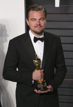 Actor Leonardo DiCaprio poses with his Best Actor award for the Revenant as he arrives to the 2016 Vanity Fair Oscar Party in Beverly Hills, California on February 28, 2016. Photo: Adrian Sanchez-Gonzalez/AFP/Getty Images.