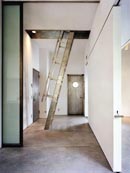 A leaned ladder makes more intense the transition between the ground floor studio and the residential area on the upper floor 